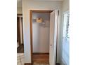 Hall coat closet with white shelving, wooden trim and bi-fold door at 3536 Countrybrook Ln # 13, Palm Harbor, FL 34684
