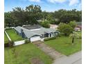 Wide aerial view showing a lovely home with a screen enclosed pool and a large grassy yard at 37331 Hickory Hill Ln, Dade City, FL 33525