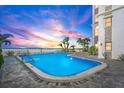 Relaxing pool area with ocean view and palm trees. Beachfront property at 4950 Gulf Blvd # 404, St Pete Beach, FL 33706