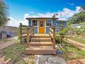 Charming back porch with wooden railing, set amidst a lush backyard at 5005 Tangerine S Ave, Gulfport, FL 33707