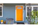 Inviting home featuring a vibrant orange front door and charming architectural details at 5005 Tangerine S Ave, Gulfport, FL 33707