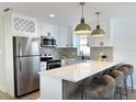 Bright kitchen with stainless steel appliances, breakfast bar, and white cabinets at 5151 7Th N Ave, St Petersburg, FL 33710