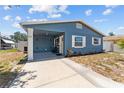 Charming blue home with a well-manicured yard and covered entrance at 546 90Th N Ave, St Petersburg, FL 33702