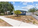 Charming blue single story home with small palm tree in front yard at 546 90Th N Ave, St Petersburg, FL 33702