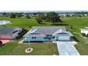 Aerial view of a charming single-story home with a spacious front yard in a tranquil neighborhood at 624 La Jolla Ave, Sun City Center, FL 33573