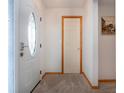 Bright and inviting foyer with a decorative front door and neutral carpeting at 624 La Jolla Ave, Sun City Center, FL 33573