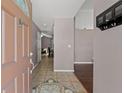 Warm and inviting foyer featuring tile flooring, a view into the living area, and a coat rack at 6324 35Th Avenue E Cir, Palmetto, FL 34221