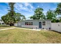 Cozy single-story home featuring a landscaped yard and white picket fence at 6601 13Th N St, St Petersburg, FL 33702