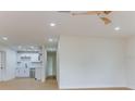 Open-concept living space with modern lighting, fresh paint, and a view into the updated kitchen at 7620 N 74Th St, Pinellas Park, FL 33781