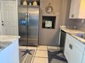Well-appointed kitchen boasting stainless steel refrigerator, granite counters, and ample cabinet space at 7800 125Th St, Seminole, FL 33772