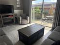 Cozy living room with neutral tones, sliding glass doors to the patio, and a fireplace for warmth at 7800 125Th St, Seminole, FL 33772