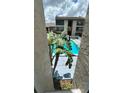 Condo community pool surrounded by greenery at 8602 Huron Court # 47, Tampa, FL 33614