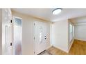 Inviting entryway with decorative front door and sidelights, showcasing the light wood flooring at 9218 Memorial Hwy, Tampa, FL 33615