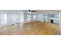 Bright and airy living room showcasing light wood floors, ample natural light, and a built-in bar area at 9218 Memorial Hwy, Tampa, FL 33615