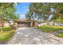 Beautiful home with stone accents, mature trees, manicured lawn and a two car garage at 9309 120Th St, Seminole, FL 33772
