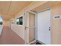 Condo entryway featuring a secured door with storm door and unit number 502 at 9461 Harbor Greens Way # 502, Seminole, FL 33776