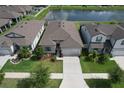 An aerial shot of a well-maintained home, showcasing its proximity to a serene pond and neighborhood at 10308 Malvasia Ave, Riverview, FL 33578