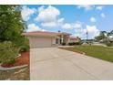 Beautiful single-story home featuring a tile roof, two-car garage, and landscaped front yard at 11411 Terrell, Spring Hill, FL 34606