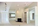 Bright living room featuring a fireplace, built-in shelving, and vaulted ceiling with track lighting at 12206 N 53Rd St, Temple Terrace, FL 33617