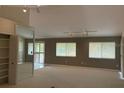 Spacious living room with three large windows and track lighting at 12206 N 53Rd St, Temple Terrace, FL 33617