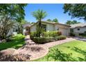 Charming single-story home with a manicured lawn and brick walkway at 12209 Glencliff Cir, Tampa, FL 33626