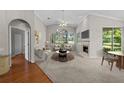 Bright living room with large windows, a fireplace, neutral furnishings and vaulted ceiling at 12209 Glencliff Cir, Tampa, FL 33626