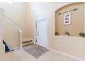 Inviting foyer with tile flooring, staircase, and decorative accents at 12624 White Bluff Rd, Hudson, FL 34669