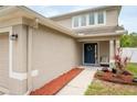 Close-up showcasing the home's front door, tidy yard, and well-kept landscaping at 12624 White Bluff Rd, Hudson, FL 34669