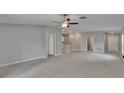 Open-concept living space with sleek tile flooring, recessed lighting, and seamless flow to the kitchen at 13187 Palmerston Rd, Riverview, FL 33579