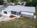 An elevated view of the home featuring new roof, landscaped front yard, and white exterior at 1415 Yale Dr, Holiday, FL 34691