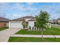 Well-maintained single-Gathering home with a lush green lawn and a neatly paved driveway at 15403 Wicked Strong St, Sun City Center, FL 33573