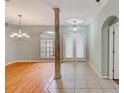 Bright foyer with tile flooring, a decorative column, and natural light from front windows at 1610 Stetson Dr, Wesley Chapel, FL 33543