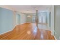 Open-concept living room featuring hardwood floors and abundant natural light at 1610 Stetson Dr, Wesley Chapel, FL 33543