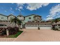 Charming townhomes showcase light paint, arched windows and terra cotta driveways, perfect for low-maintenance living at 1710 Lago Vista Blvd, Palm Harbor, FL 34685