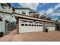 Inviting townhome featuring an attached garage and arched windows, set in a well-maintained neighborhood at 1710 Lago Vista Blvd, Palm Harbor, FL 34685