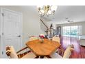 Inviting dining room showcasing a wooden table set, chandelier lighting, and stairway to second level at 2007 Searay Shore Dr, Clearwater, FL 33763