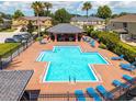 Aerial view of a community pool with lounge chairs and a covered seating area surrounded by well-maintained landscaping at 2007 Searay Shore Dr, Clearwater, FL 33763