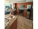 A spacious kitchen with stainless steel appliances, tile backsplash, and stone countertops at 2043 Sugarbush Dr, Holiday, FL 34690