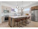 Modern kitchen boasts stainless steel appliances, sleek countertops, and a center island with seating at 2120 4Th S St, St Petersburg, FL 33705