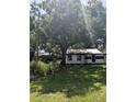 Quaint home nestled beneath a large shade tree in an expansive lawn at 2414 S 67Th St, Tampa, FL 33619