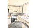 Bright kitchen featuring a double sink, white cabinets, and a range at 2414 S 67Th St, Tampa, FL 33619