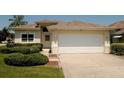 Beautiful one-story home with a two-car garage, well-kept lawn, and attractive landscaping at 2784 Alexander Dr, Clearwater, FL 33763
