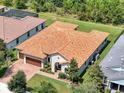 Aerial view of the home showing the red tile roof, backyard and landscaping, and neighborhood surroundings at 3236 Barbour Trl, Odessa, FL 33556