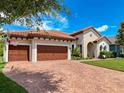 Beautiful home with a paver driveway, two-car garage, well-maintained lawn, and mature landscaping at 3236 Barbour Trl, Odessa, FL 33556