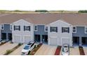 An exterior of modern townhomes with garages and landscaped driveways at 32977 Kaloko Rd, Wesley Chapel, FL 33543