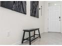 Inviting entryway with a sleek bench and stylish decor, leading into a bright and airy home at 33668 Elm Hill Branch, Wesley Chapel, FL 33545
