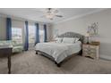 Bright bedroom with plush carpeting, a comfortable queen-sized bed, and lots of natural light from large windows at 4077 Cadence Loop, Land O Lakes, FL 34638