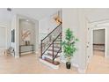 Bright foyer with staircase featuring tile flooring and modern decor at 4306 Barracuda Dr, Bradenton, FL 34208