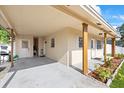 Covered porch featuring painted support beams, neutral siding, and a welcoming entrance at 5109 N 30Th St, Tampa, FL 33610