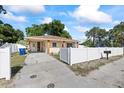 Single-story home with a white fence and a large driveway at 5109 N 30Th St, Tampa, FL 33610